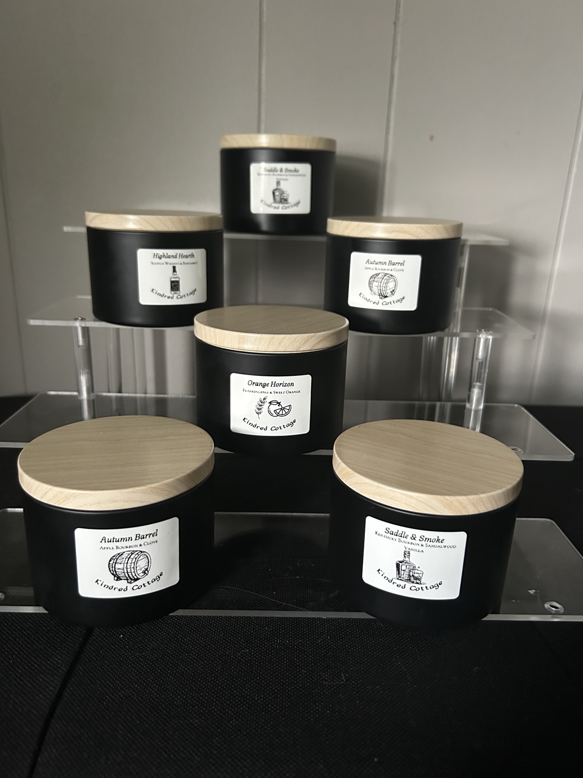 Assortment of black candle jars with wooden lids by Kindred Cottage