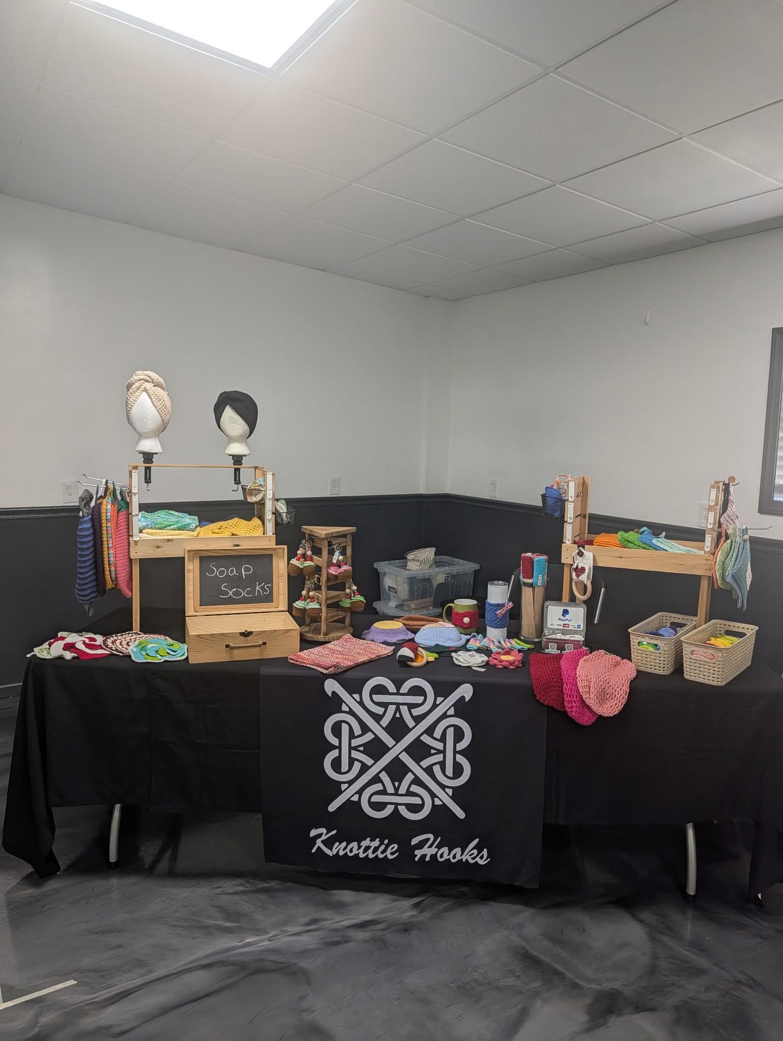 Knottie Hooks craft booth filled with colorful functional crochet items