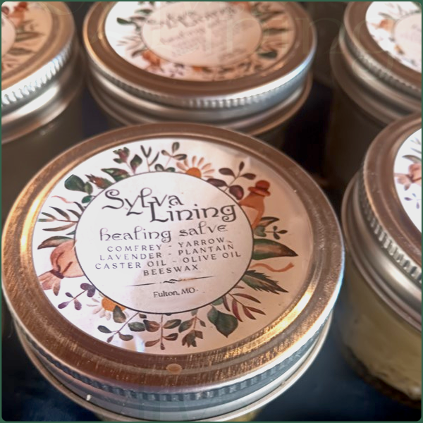 Floral-labeled jars of handmade healing salve by Sylva Lining